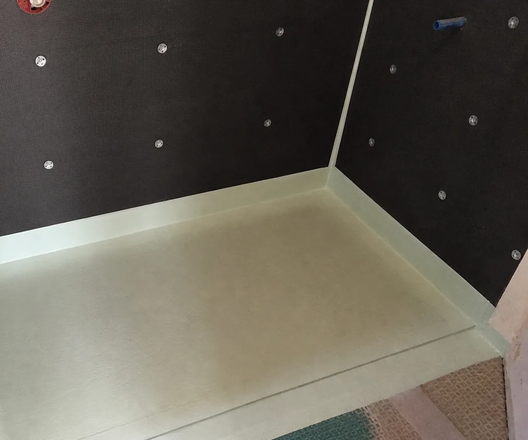 Custom shower floor and corners carefully prepared with a waterproofing membrane
