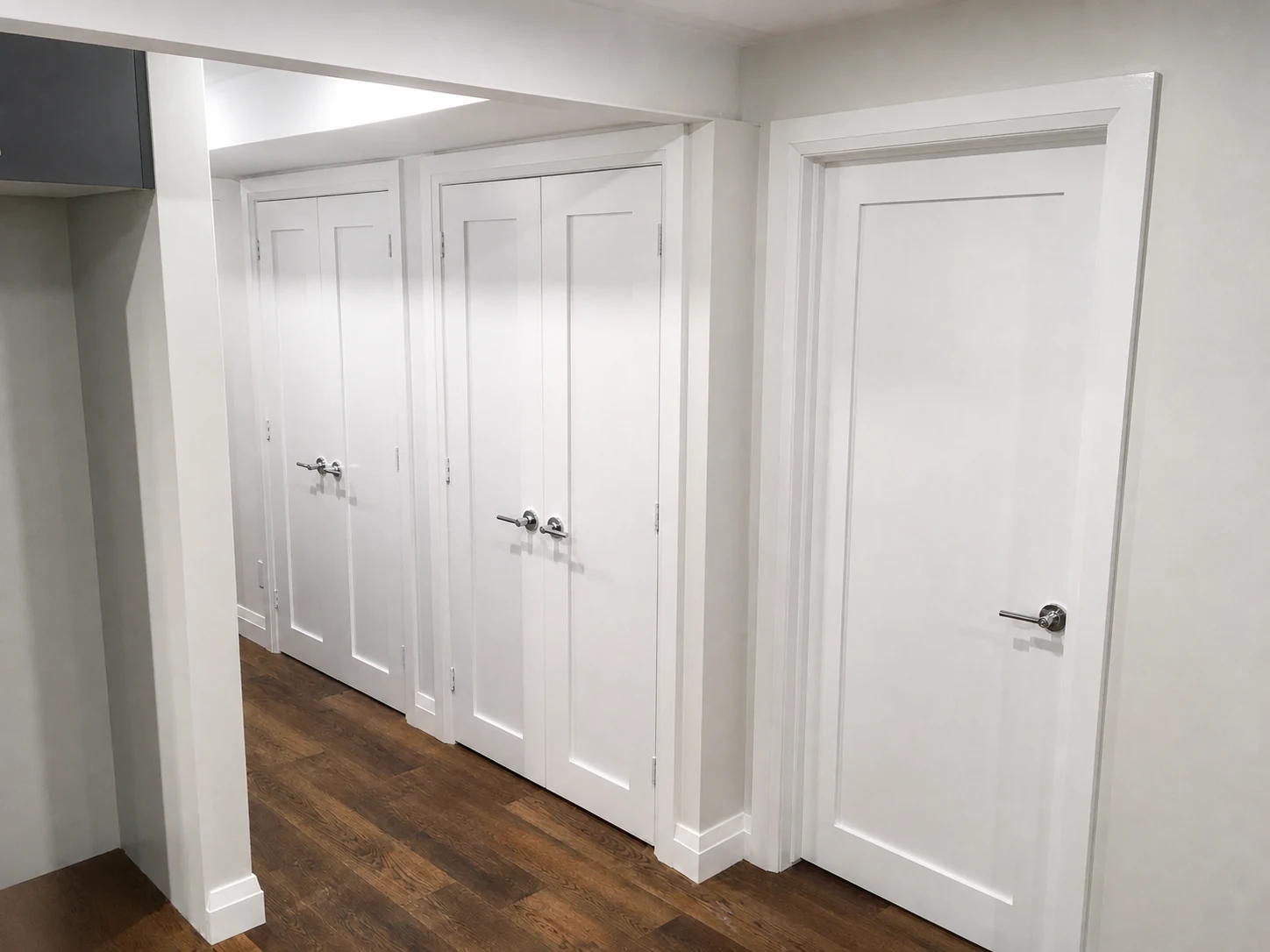 A series of carefully cased interior doors with coordinated baseboard transitions