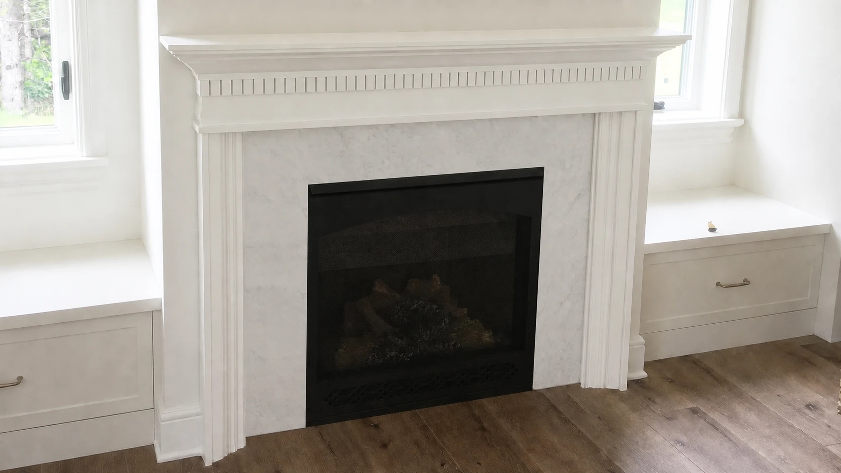 Custom fireplace mantel with fluted pilasters, dentil detail and built-in window seats
